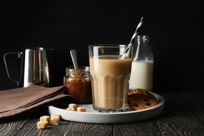 Composition with ice coffee and cookies on wooden background