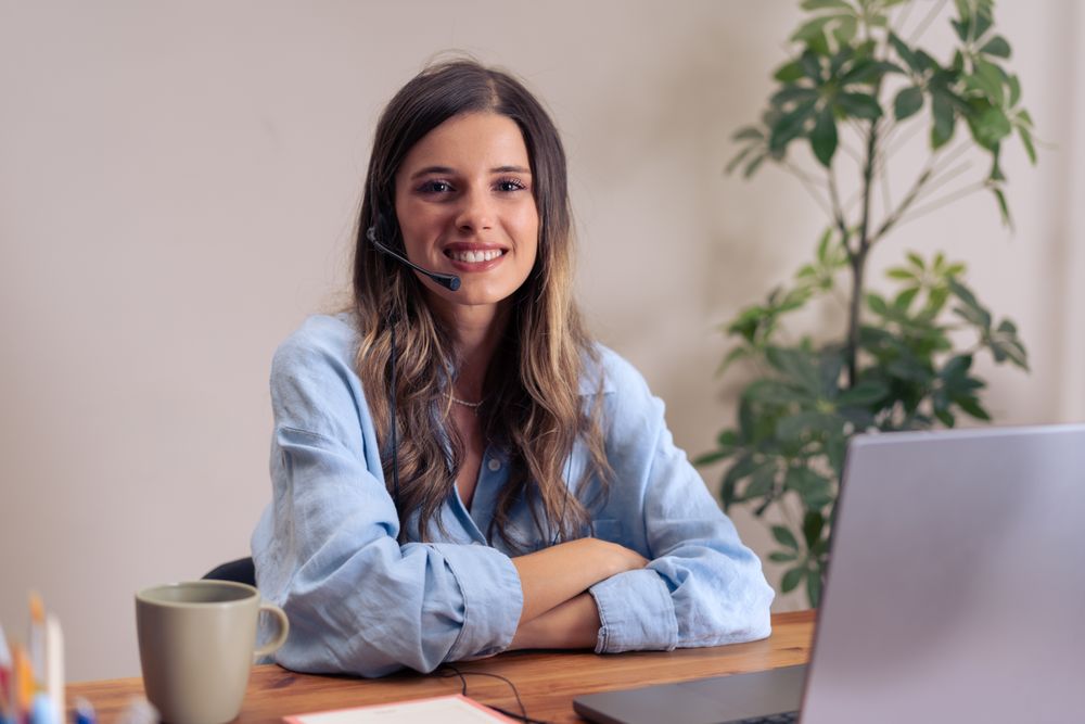 Confident female business professional participating in video conference call from stylish home office workspace setup