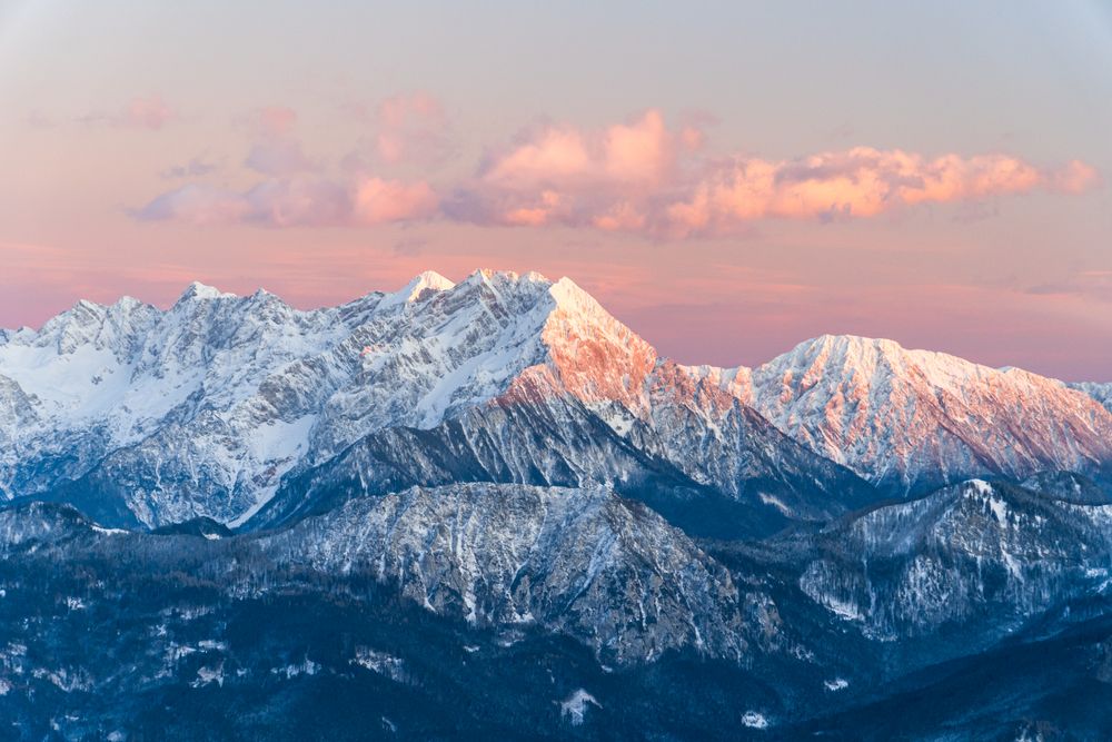 Snow covered mountain under cloudy sky