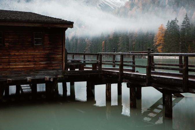 House on stilts on lake near mountains