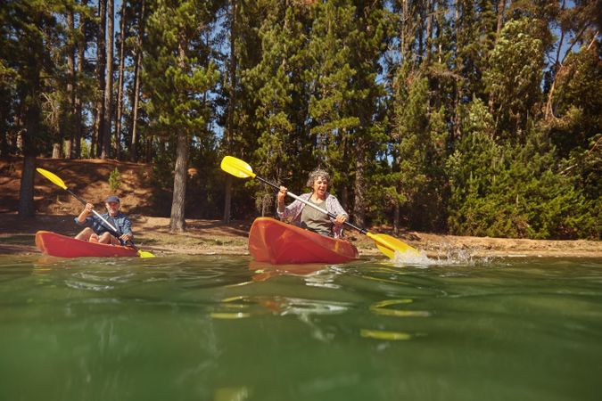 Portrait of a mature couple canoeing on a lake during a camping trip