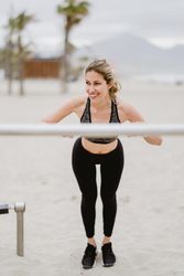 Sportswoman doing workouts in a sandy beach