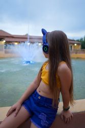 Schoolgirl resting at dusk by fountain
