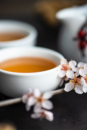 Cups of tea with floral garnish