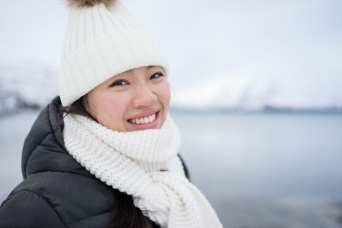 Joyful young woman in warm clothes