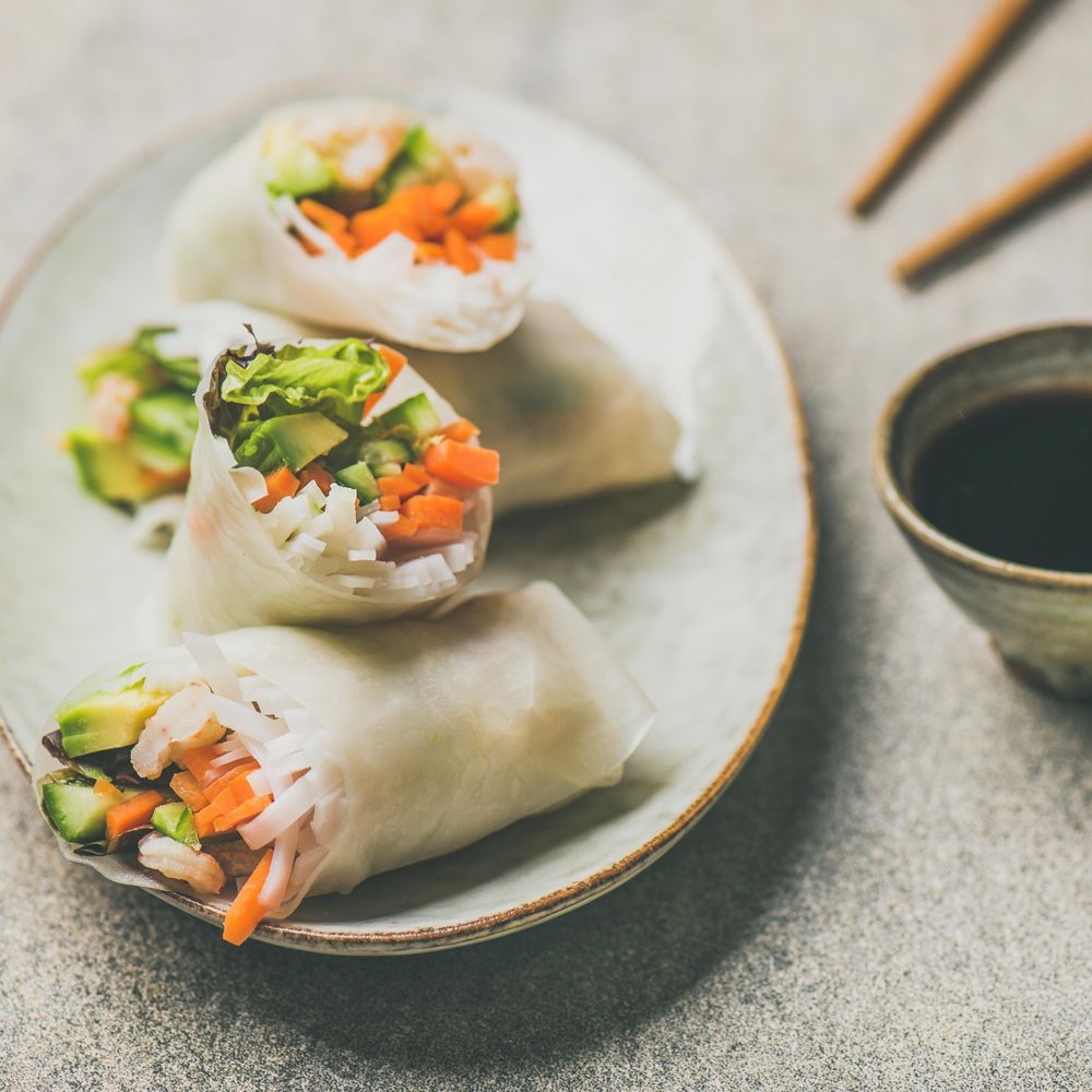 Thai spring rolls on dish beside dipping sauce