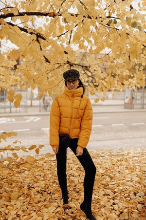 Woman standing on autumn tree