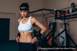 Fit young woman with motion capture sensors on her body in sports lab 0LLkr0