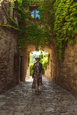Woman walking in a narrow path in a village