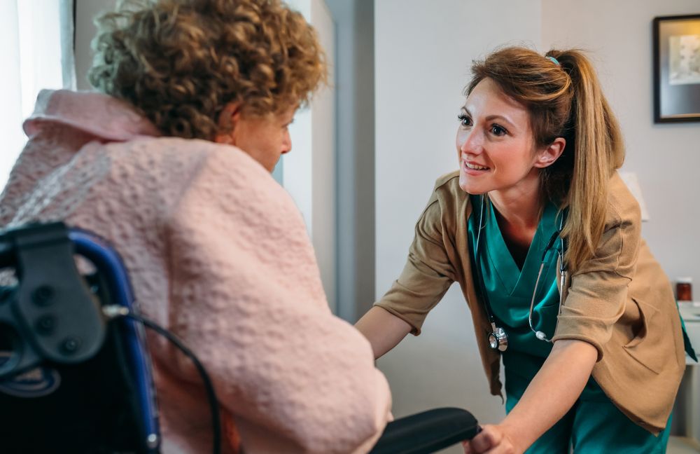 Doctor talking to patient in a wheelchair