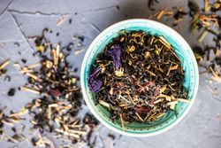 Top view of floral tea in a teal bowl