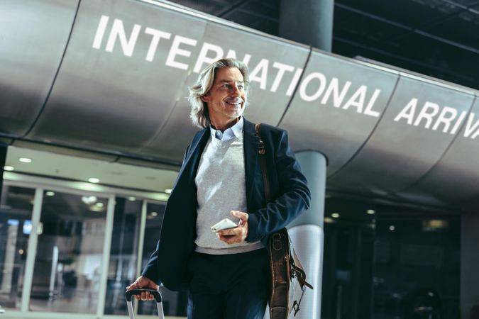 Businessman walking in an international airport terminal