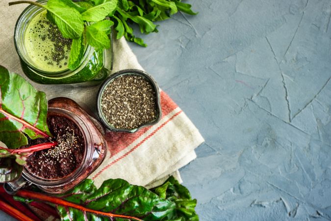 Top view of beet and green smoothies with chia seeds and copy space