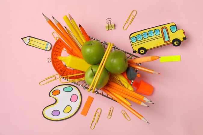 Composition with school supplies on pink background, top view