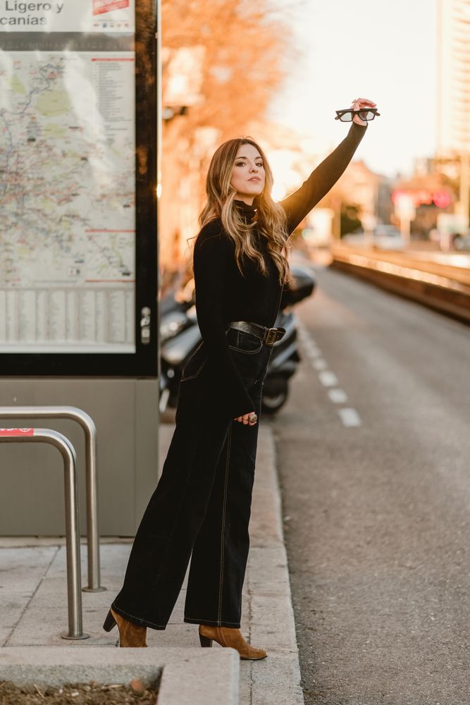 Cheerful woman hailing taxi