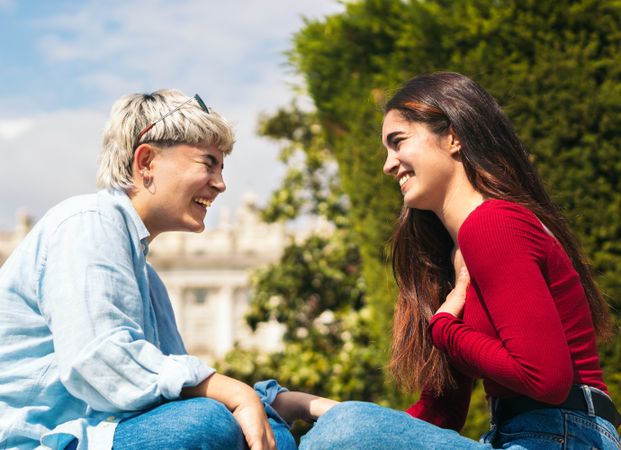 Two women sitting laughing having fun