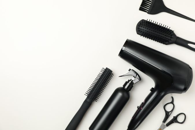 Composition with hairdresser accessories on blank background, space for text