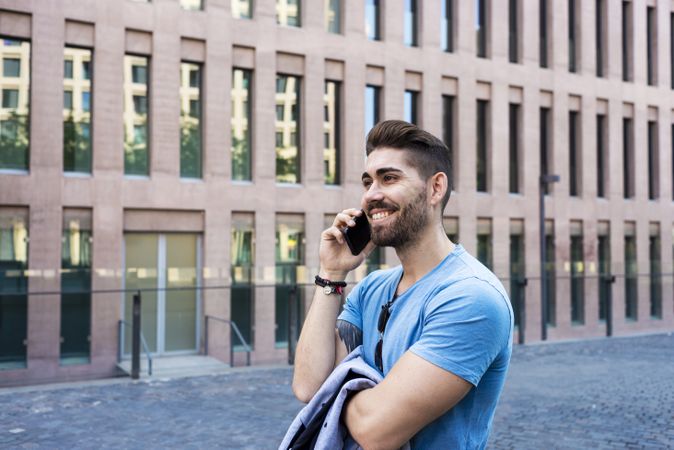 Young businessman talking on his phone outdoors