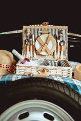 Case with drink and cutlery in car trunk