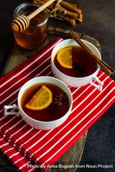 Two tea cups with lemon and star anise on red napkin 4mW6Jv