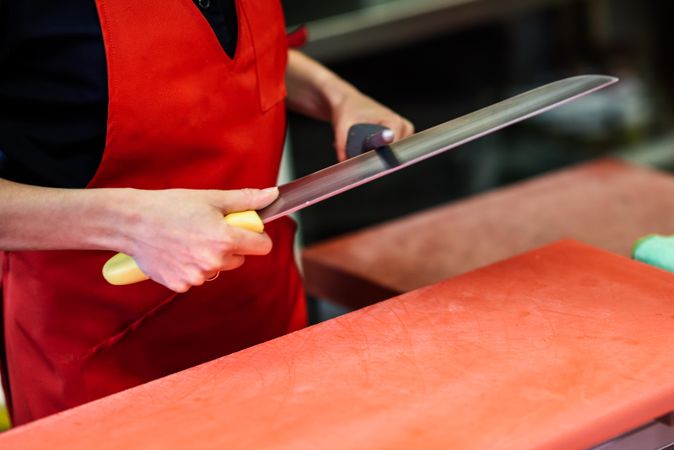 Close up of butcher sharpening knife