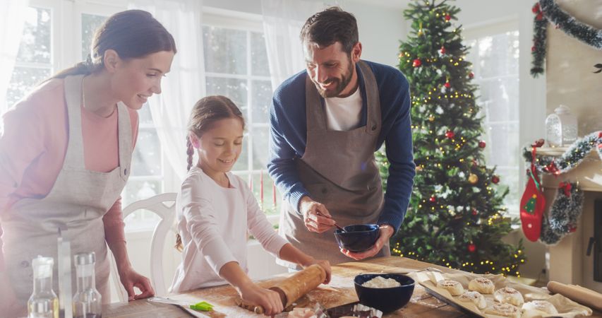 Family Celebrating the Holidays: Parents and Child Baking Together During Christmas.