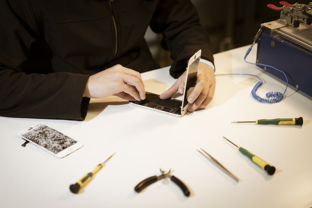 Young man repairing modern device