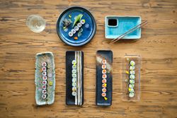 Set of various sushi rolls on wooden table