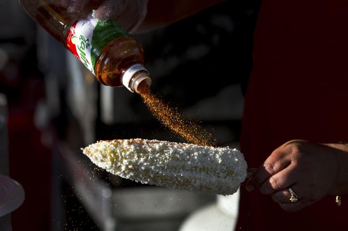 Des Moines, Iowa, USA - September 26, 2015: A vendor prepares elotes