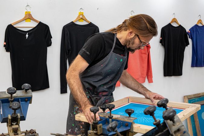 Artist printing screen in workshop