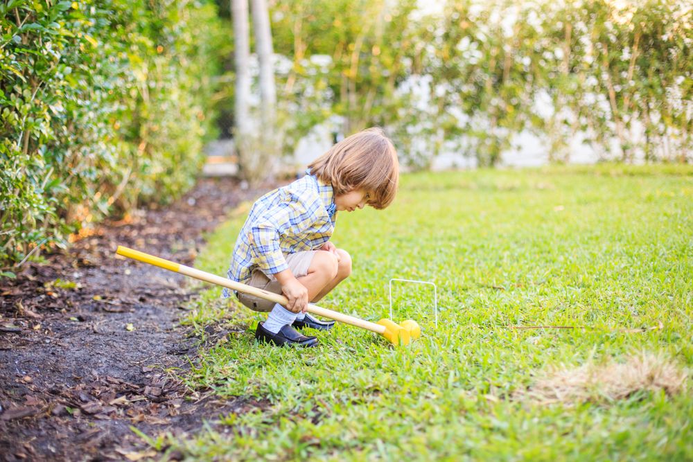 Young boy playing on green grass field