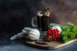 Mulled wine on bread board with Christmas baubles and decorations