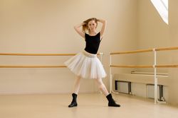 Ballerina in tutu and shoes, modern dance pose