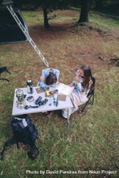 Young women having breakfast in a campsite 5oDW89