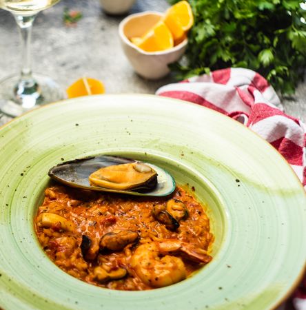Risotto with sea food served with chill wine, parsley and lemon