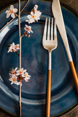 Spring table setting with blooming tree branch and cutlery