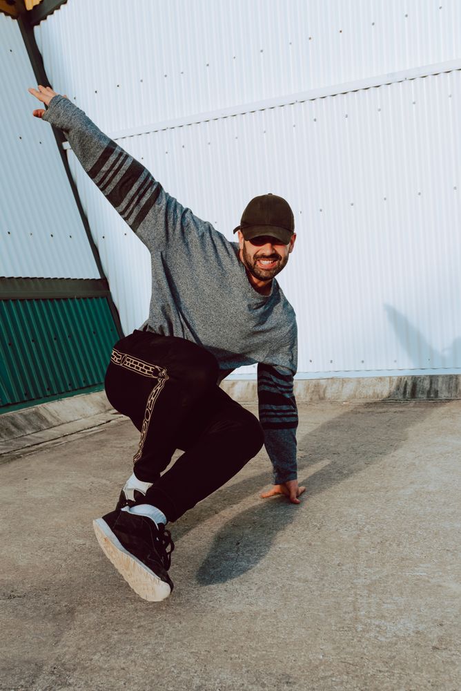 Man performing handstand near wall