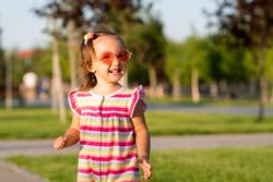 Summery toddler enjoying playing outdoors