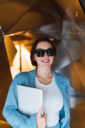 Woman with laptop in futuristic studio