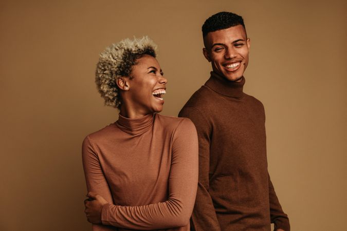 Cheerful Black couple in winter clothes