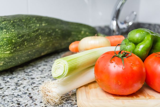 Fresh vegetables on cutting board in the kitchen