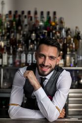 Smiling bartender standing at the counter