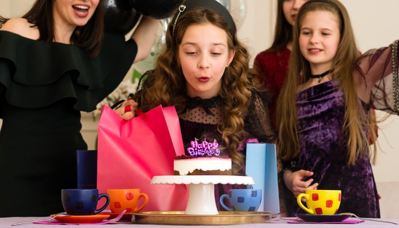 Girl blowing out birthday candles
