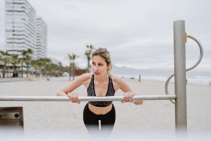 Sportswoman doing workouts in a sandy beach