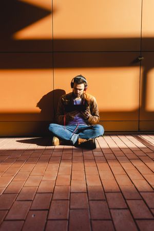 Man using tablet and headphones in modern building