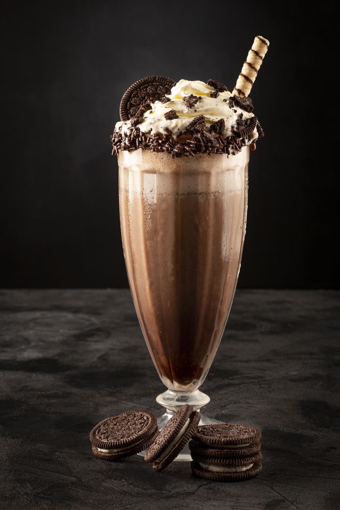 Chocolate milkshake with pieces of chocolate chip cookies.