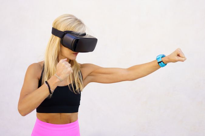 Fit woman using VR headset for movement