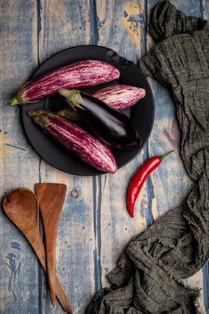 Ripe eggplants on shabby tabletop