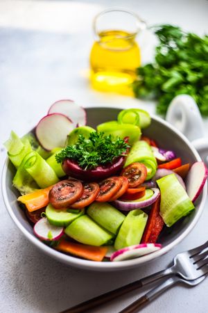 Bowl of healthy raw salad with freshly chopped vegetables