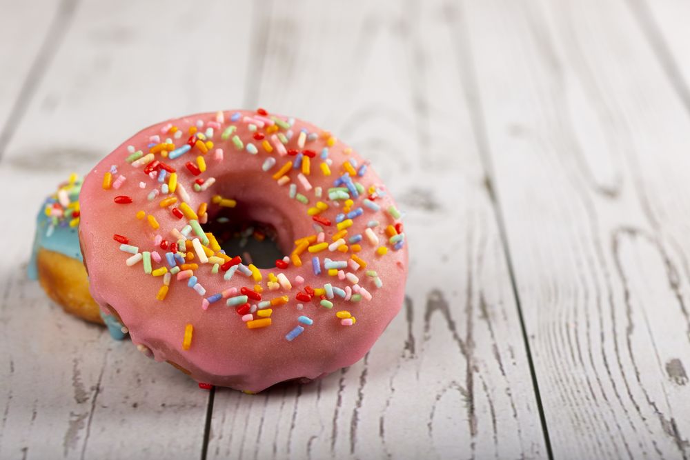 Delicious assorted colorful donuts on the table.